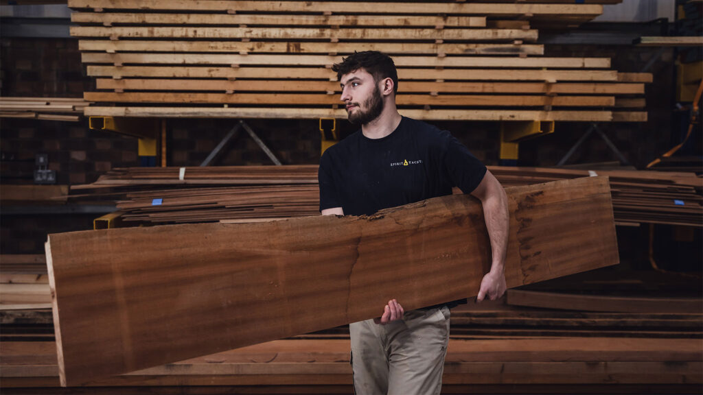 Spirit Yachts | Homepage | Craftsman carrying wood for Spirit Yacht | Luke Dorey Photography
