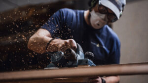 Spirit Yachts | Yachts | Craftsman sanding yacht | Luke Dorey Photography